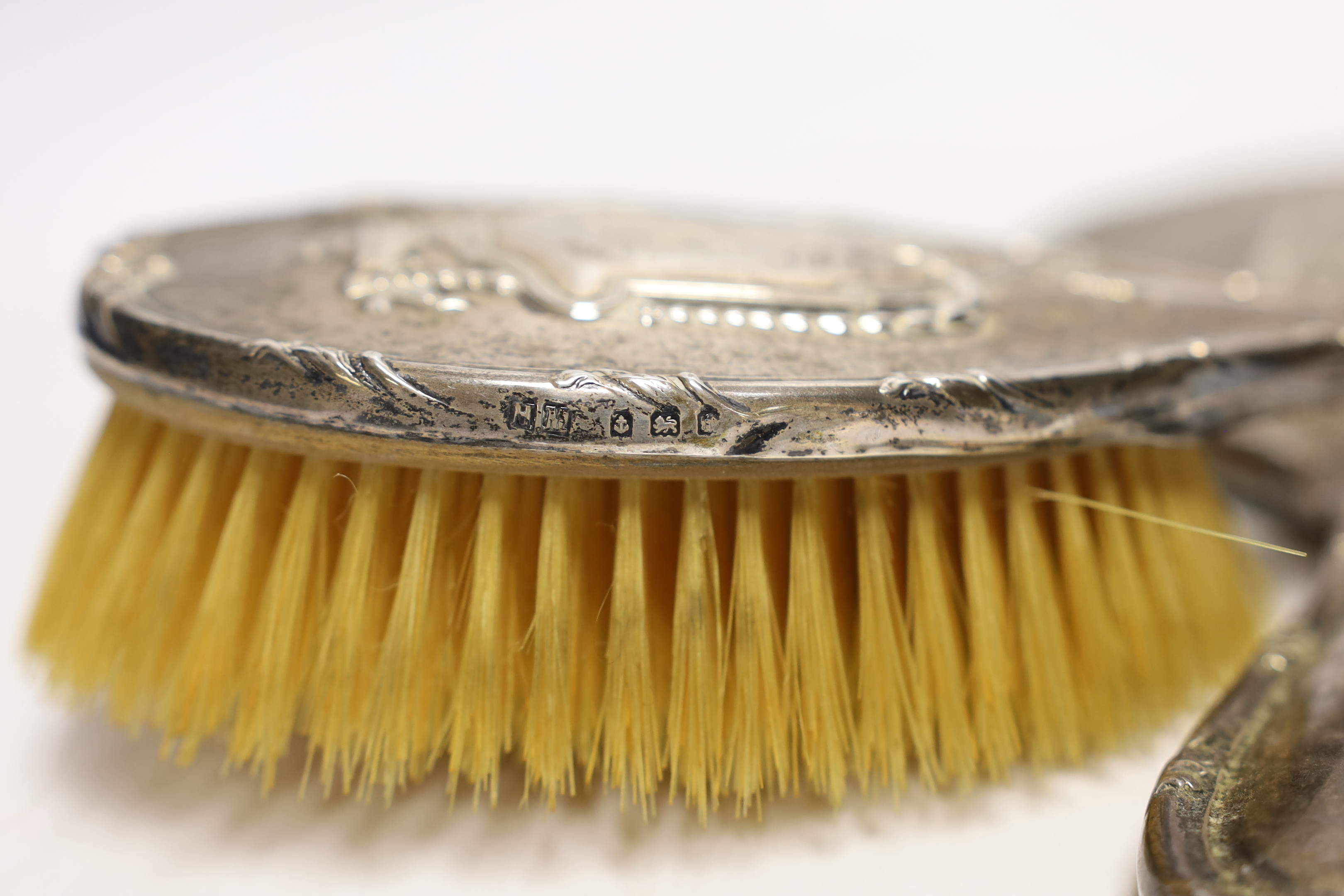An Edwardian silver mounted hand mirror and hair brush, Henry Matthews, Birmingham, 1908 and a modern 925 pill box modelled as a wrapped sweet.